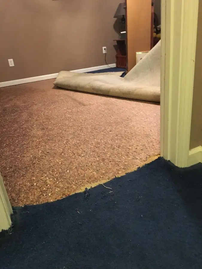 Carpet pad removal revealing water damage during Drying & Dehumidification in Oakhurst
