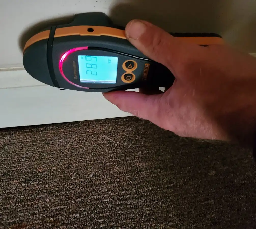 Moisture detection at baseboard during Storm Damage Restoration in Oakhurst